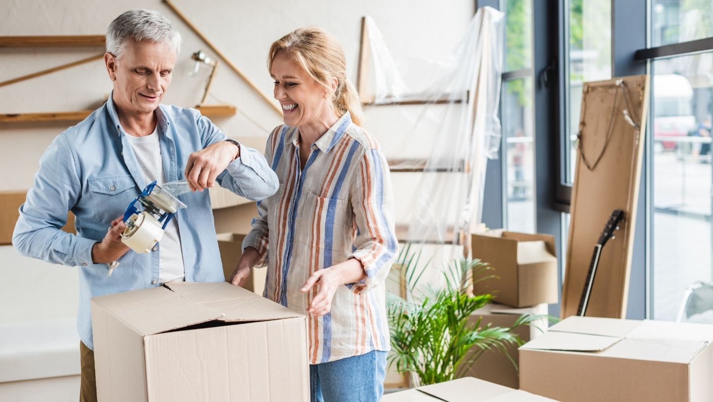 Middle Aged Couple Packing Up Home to Move