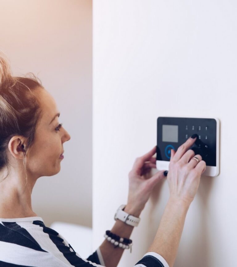 Woman using security alarm system